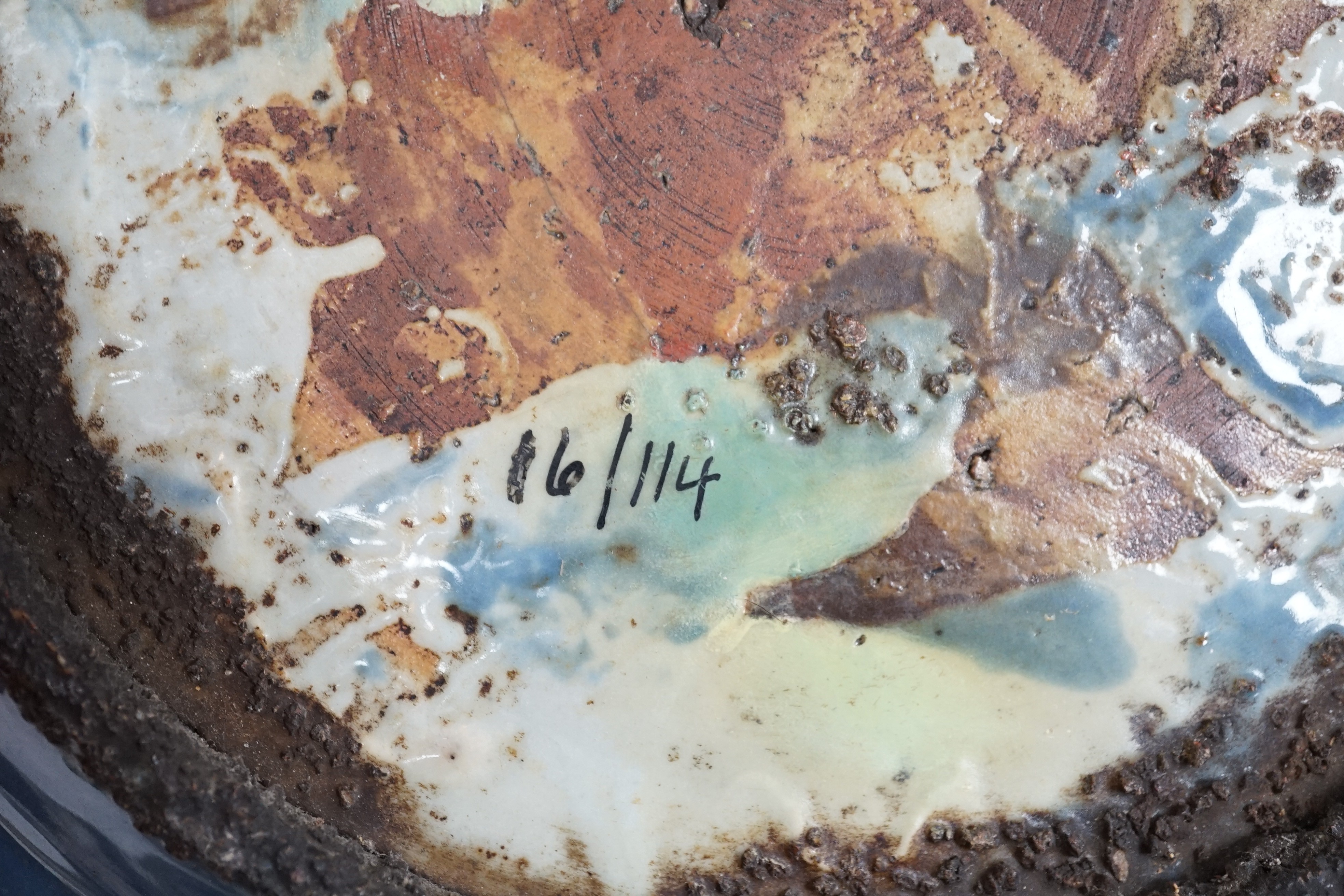 A Chinese Swatow slip-decorated blue glazed deep dish, Zhangzhou kilns, early 17th century, 38cm wide, crack to base